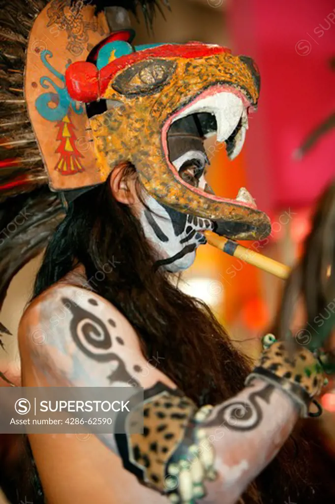 Mexico Aztec with mask plays the flute, Indian