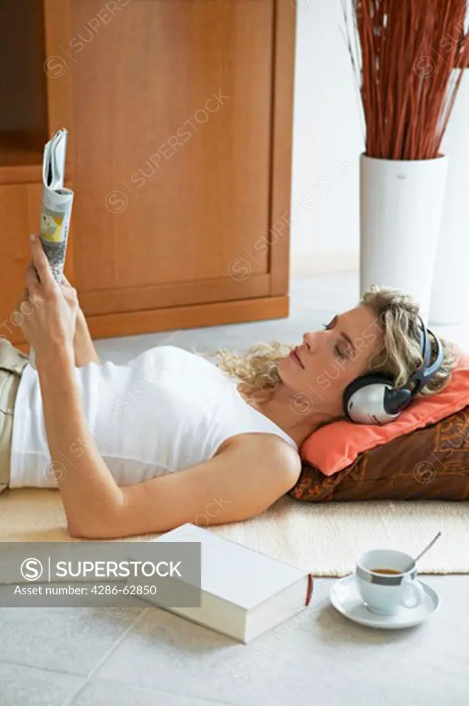 woman lying on the floor and listening to music