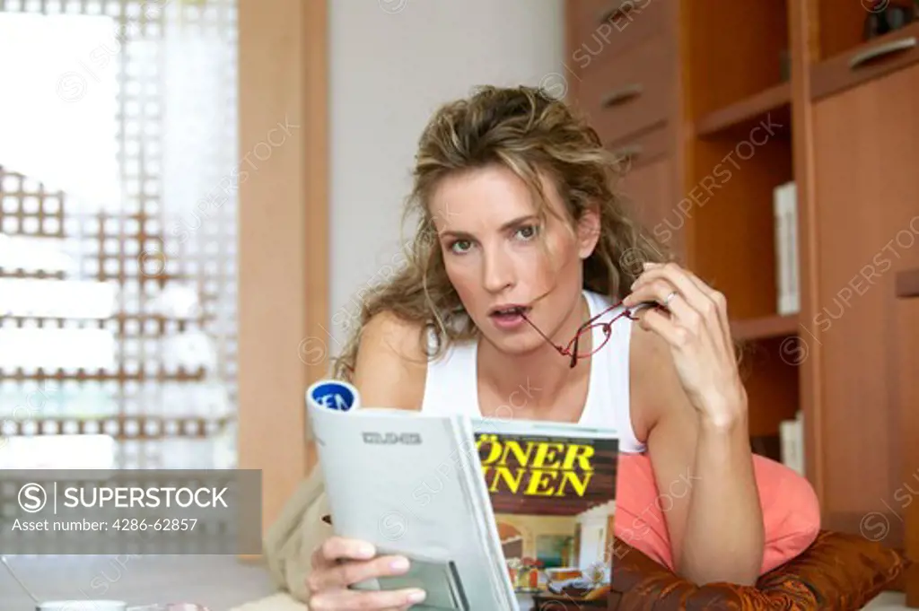 woman at home reading a magazine