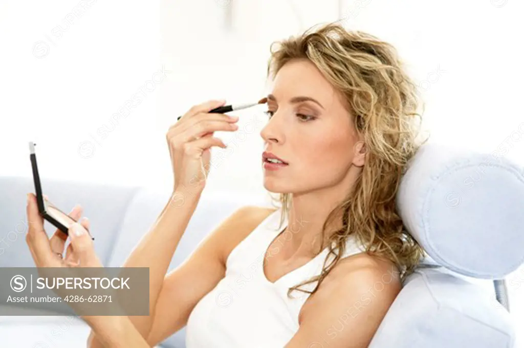 woman at home making herself up make up