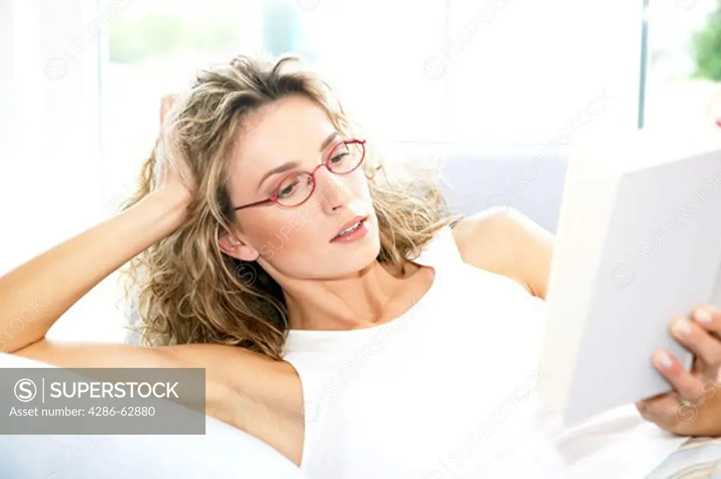 woman reading a book at home