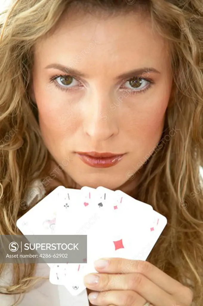 portrait of pokerface woman playing four aces