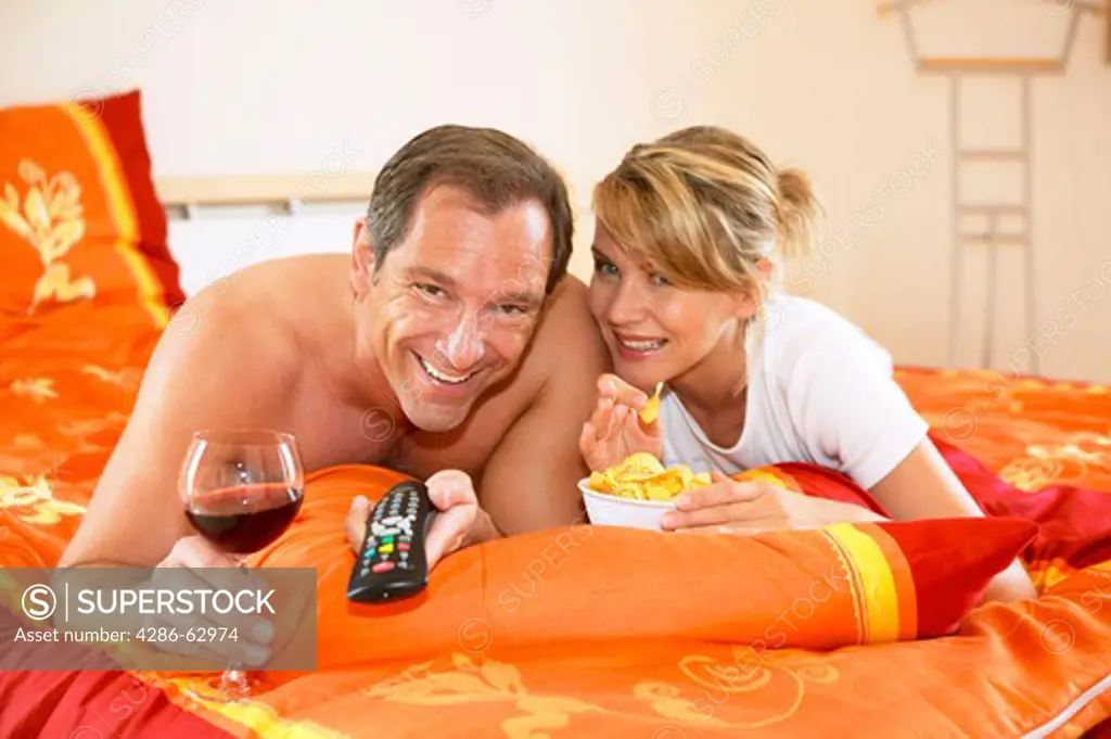 couple watching tv in bed tv evening