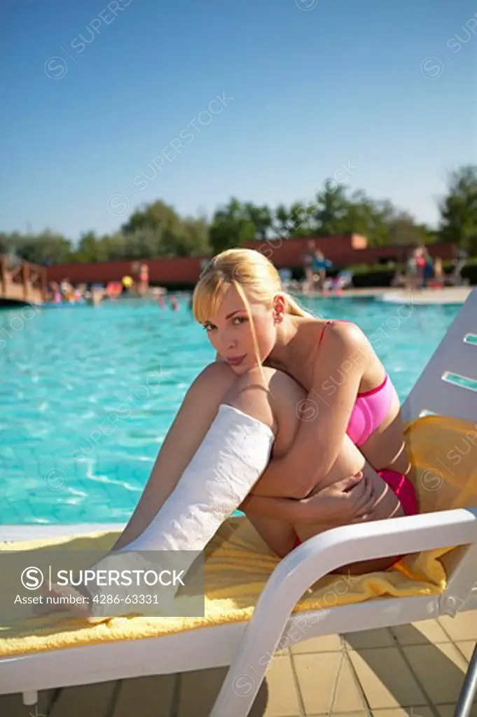 woman with leg in cast at the pool