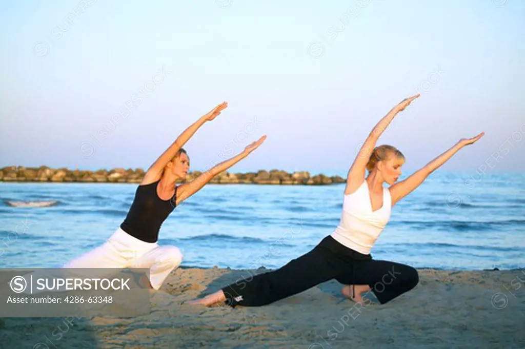 two women doing Tai Chi at the beach
