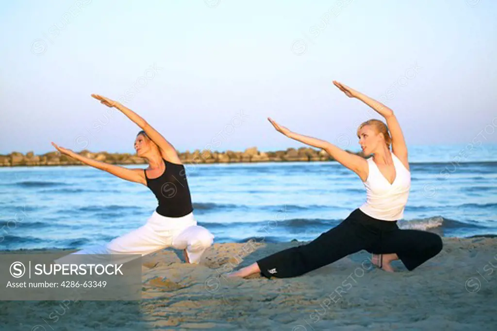 two women doing Tai Chi at the beach