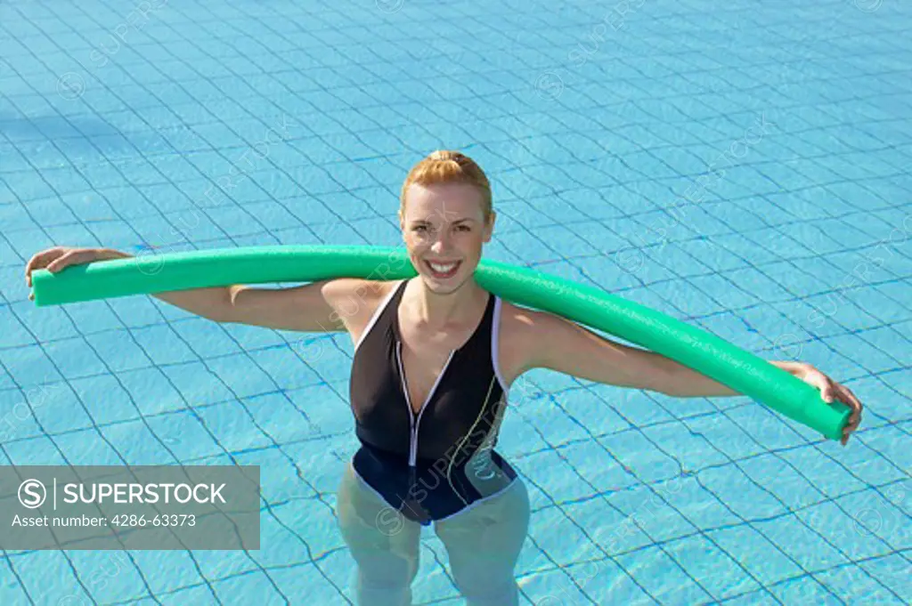 young woman doing aquaaerobic in the swimmingpool