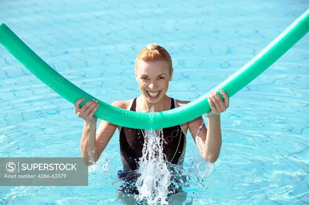young woman doing aquaaerobic in the swimmingpool