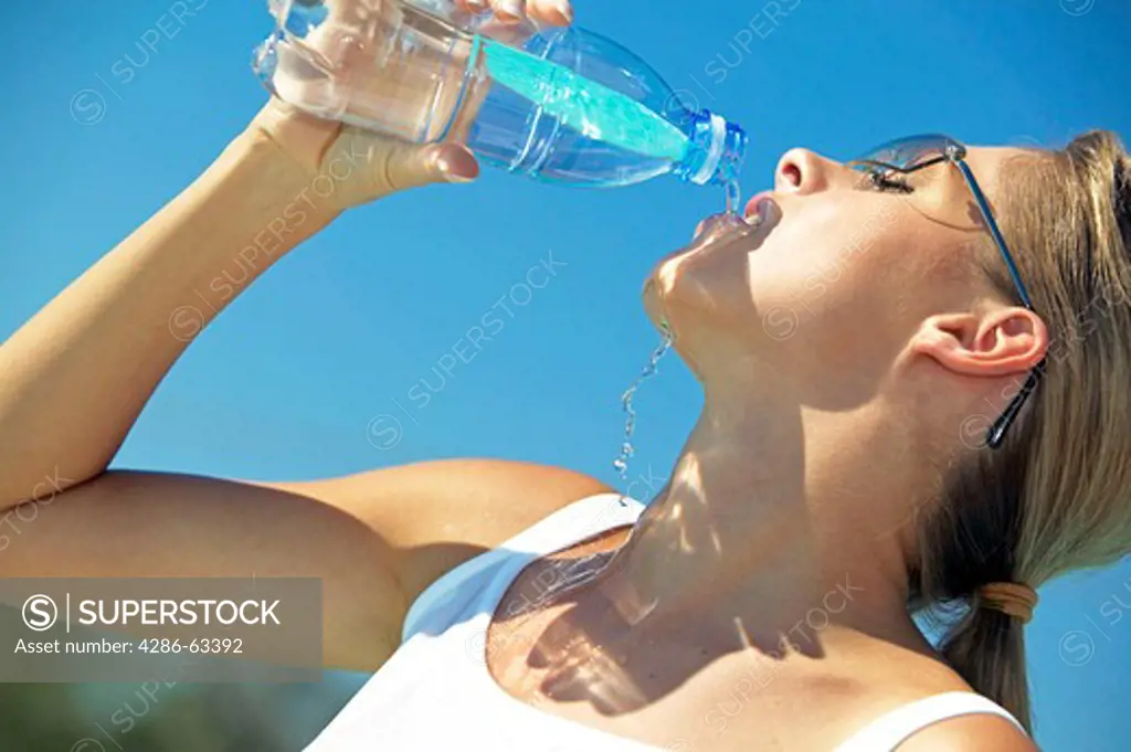 woman drinking water from a bottle