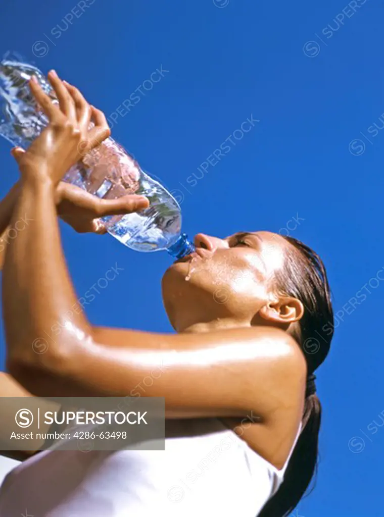 woman drinking water from a bottle