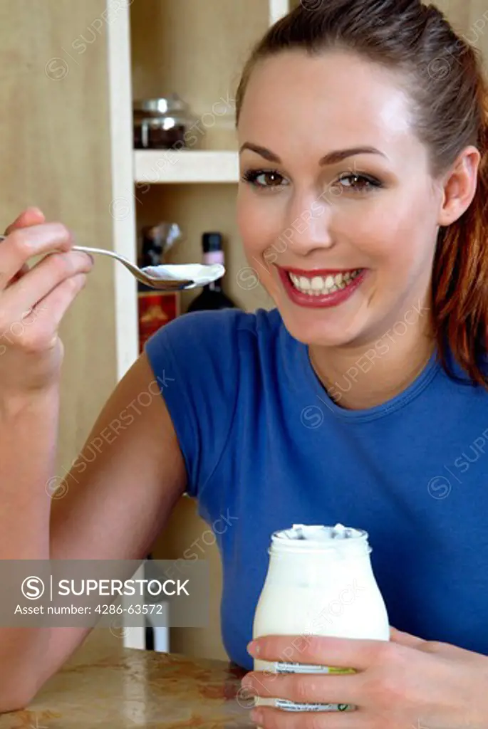 Young Woman Eating Yogurt
