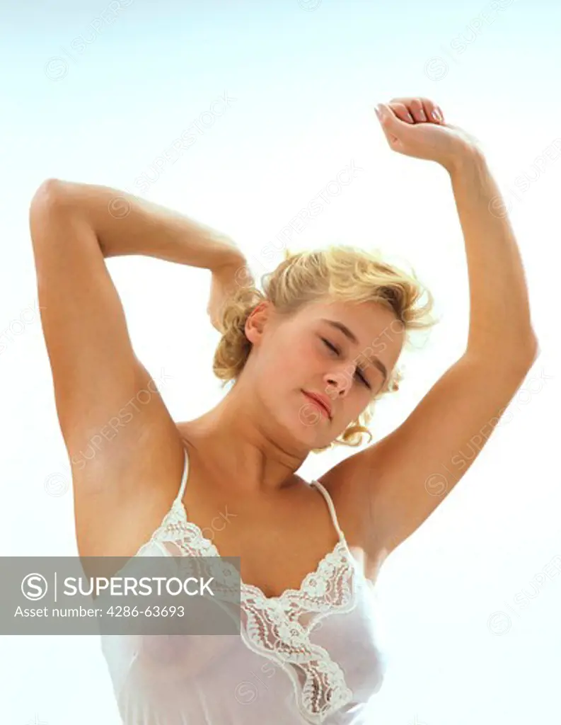 Woman stretches and stretches herself after the rising