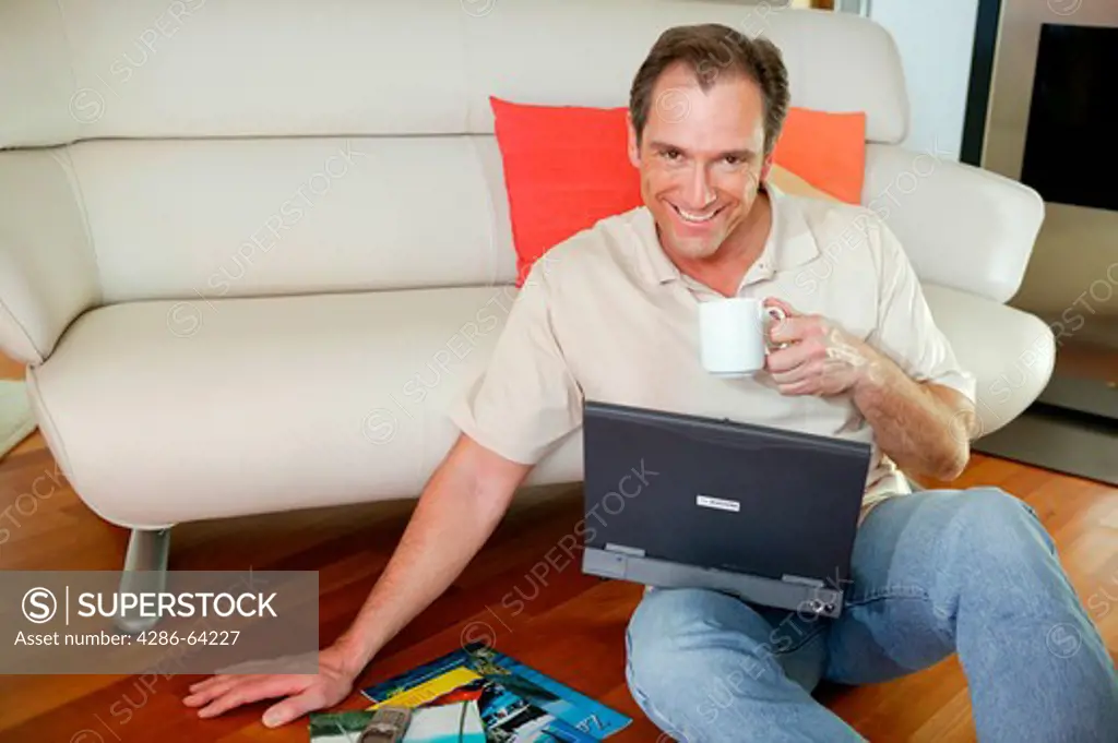man at home with notebook