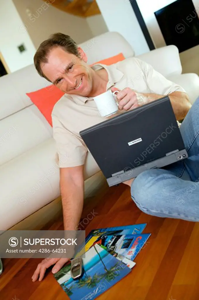 man at home with notebook