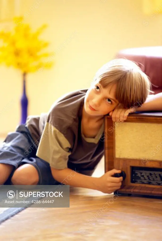 Boy hears radio, boy listening to radio