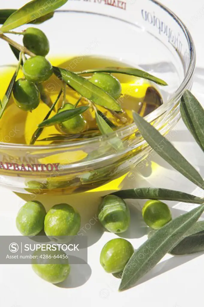 Olives and olive oil in a glass bowl