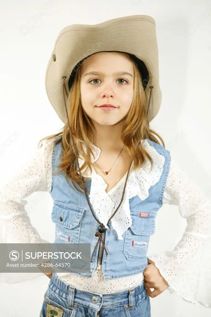 Child girl in the west outfit with stetson