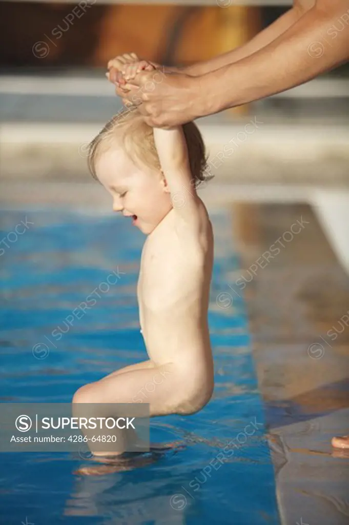 Baby goes to water with mother help