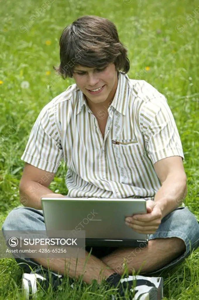 man with computer outdoors