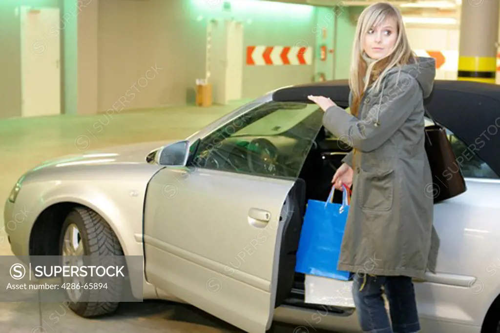 Woman with shopping bags in the garage