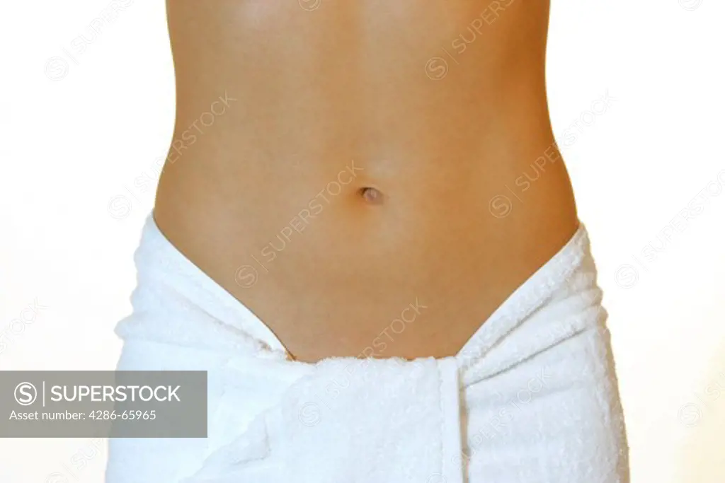 Woman with naked upper part of the body and around the hips to tied towel