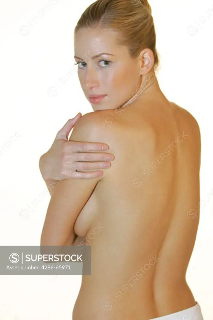 Woman with naked upper part of the body and around the hips to tied towel