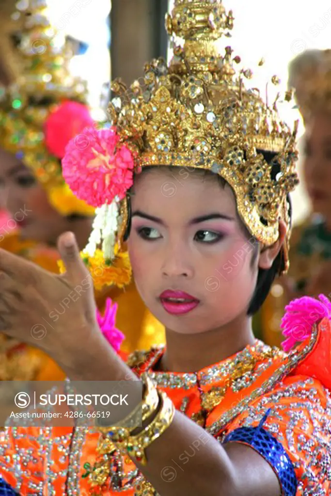 Young female Thai classical dancer in traditional costume in Wat Chachoengsao