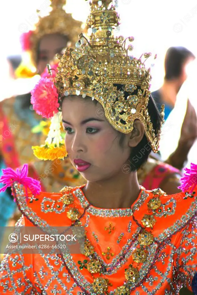 Young female Thai classical dancer in traditional costume in Wat Chachoengsao