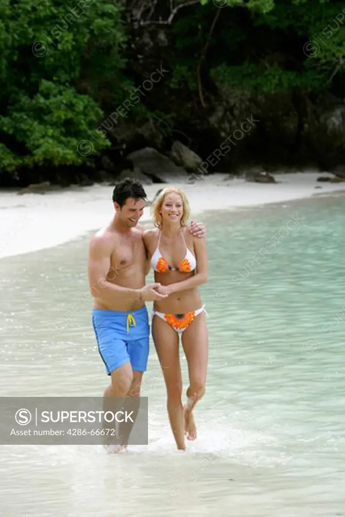 Couple in love walking at tropical beach in