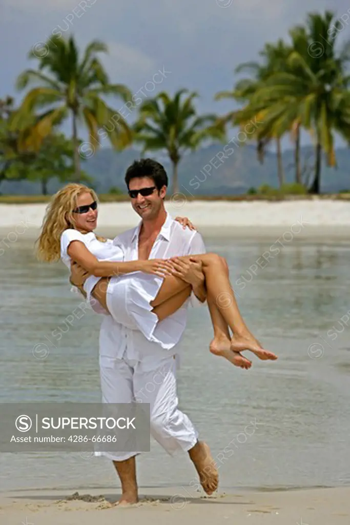 couple in love have fun at tropical beach in