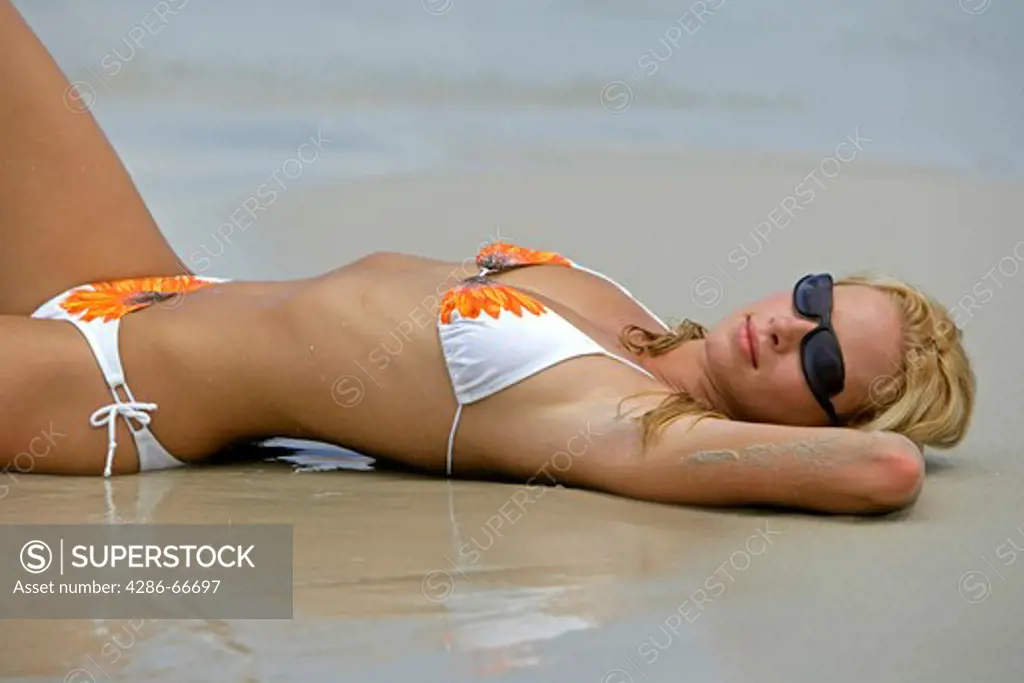 Sexy blond woman relax on tropical beach in