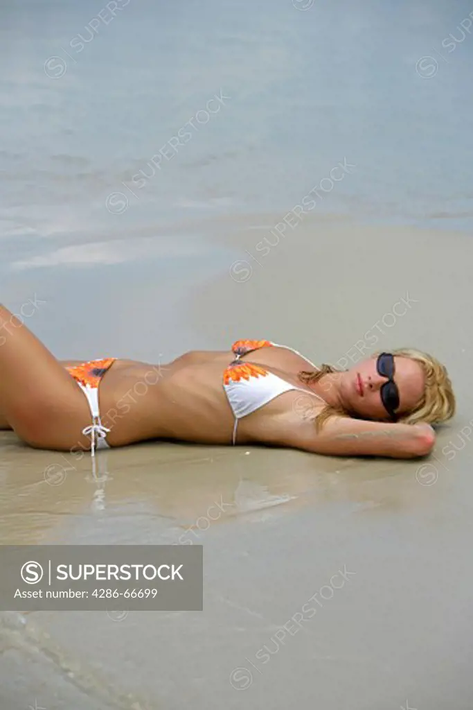 Sexy blond woman relax on tropical beach in