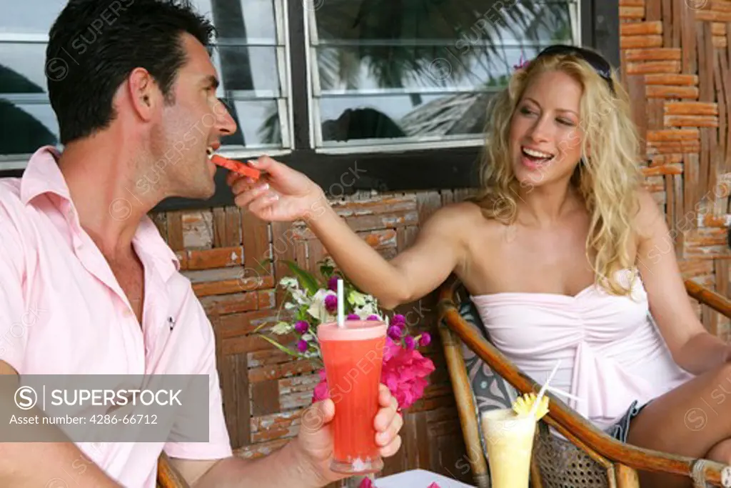 Couple relax with drinks at yao yai island resort
