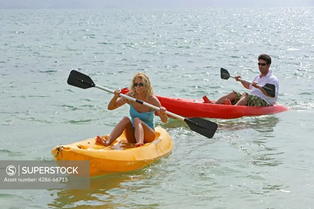 Couple have fun with sea kayaks