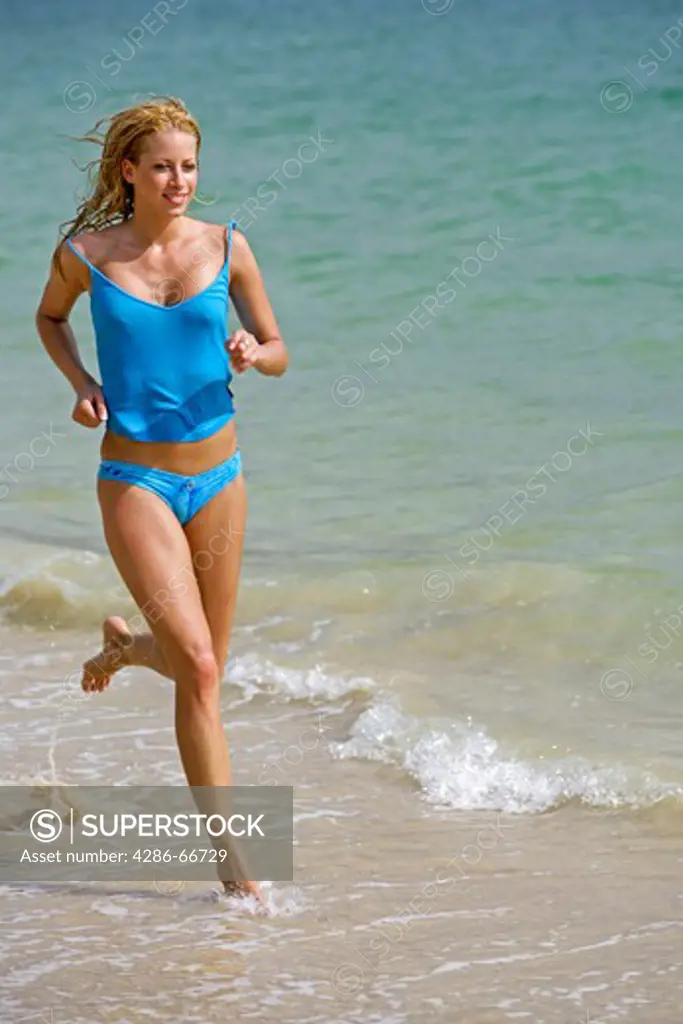 woman jogging on the beach at yao yai island resort