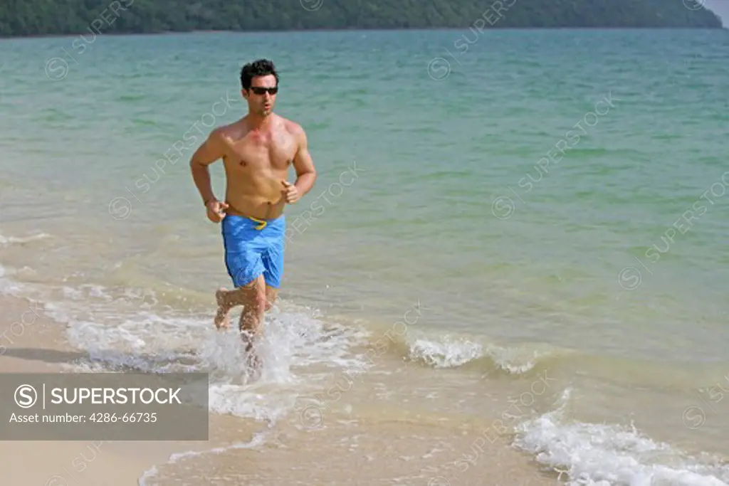 man jogging on the beach at yao yai island resort