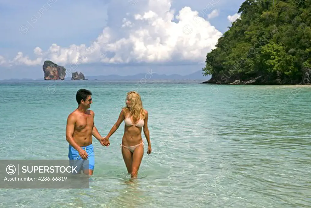 couple in love enjoy summer holidays at tropical beach in