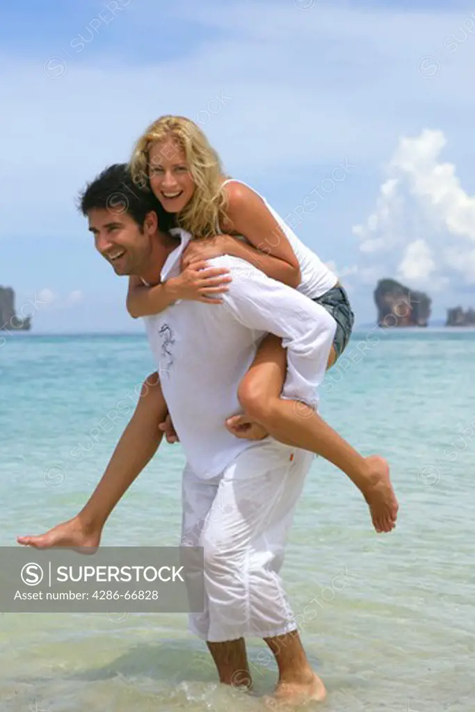 couple in love have a lot of fun at holiday on tropical beach in