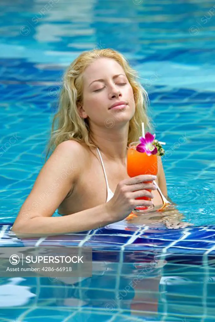 beauty blonde woman enjoying holiday in pool