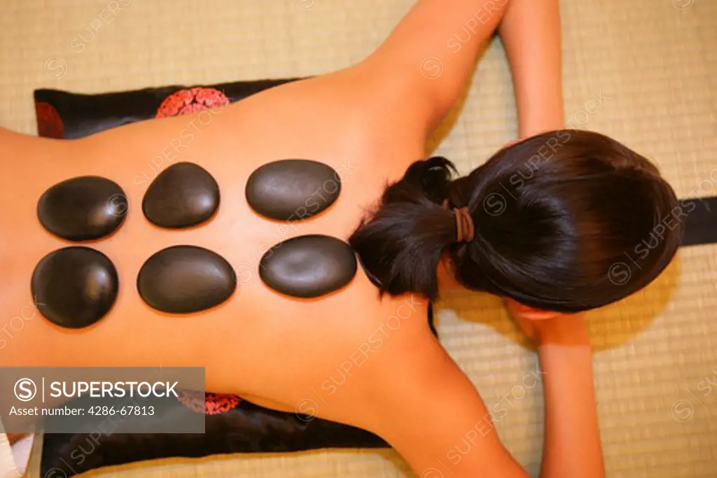 woman relaxing, having a hot stone, lastone therapy
