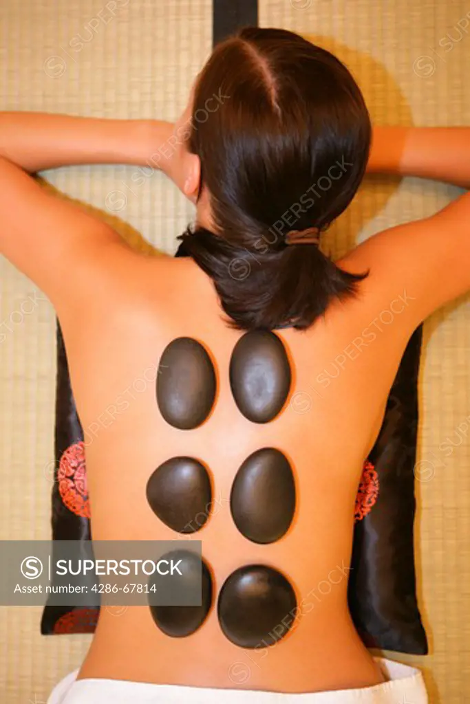 woman relaxing, having a hot stone, lastone therapy