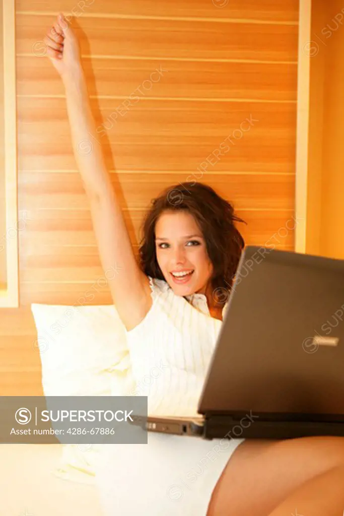 Woman with laptop in a hotel room