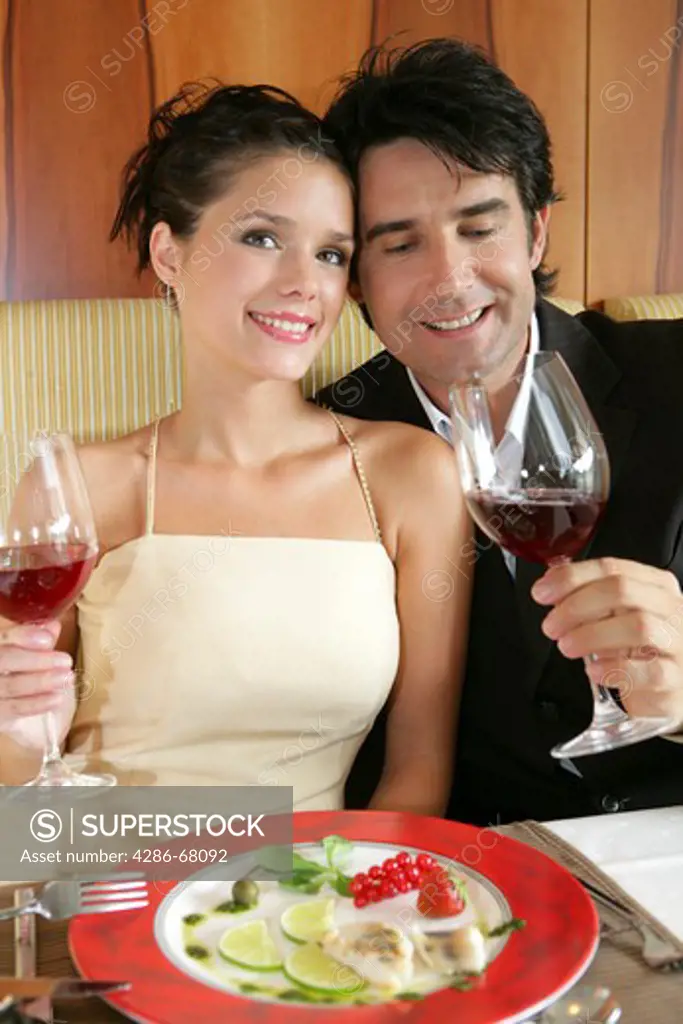 couple in love drinking red wine in a restaurant
