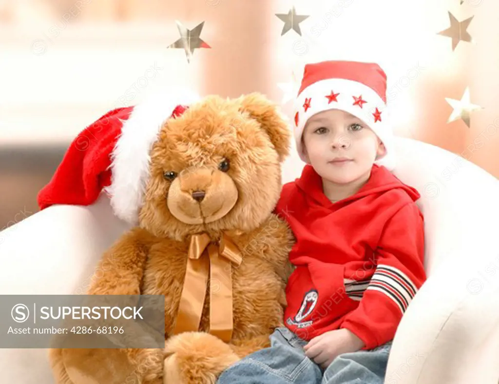 child with teddy bear at Christmas