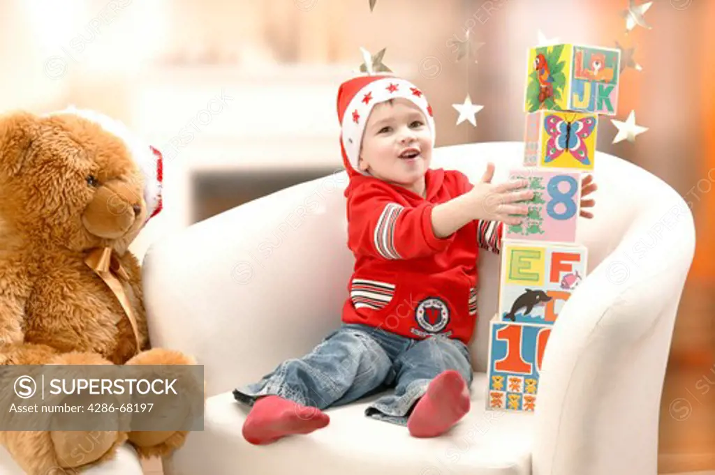 child with teddy bear at Christmas
