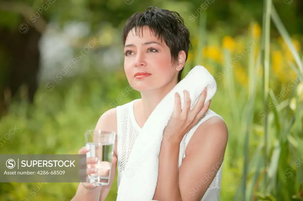 woman sitting in garden drinkin water