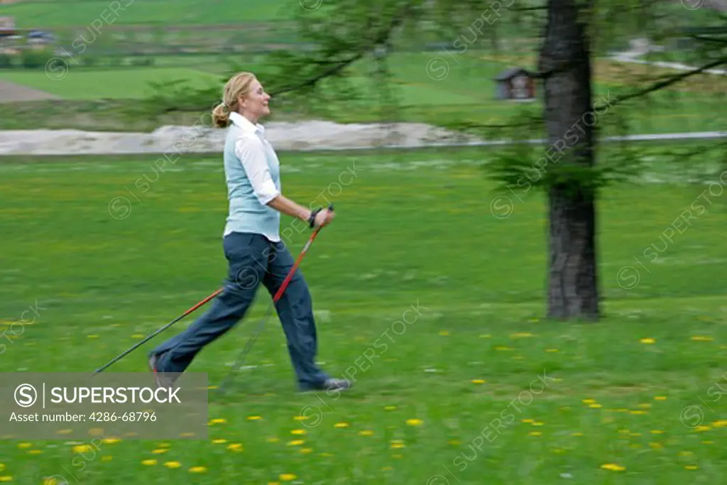Blonde mature woman nordic walking