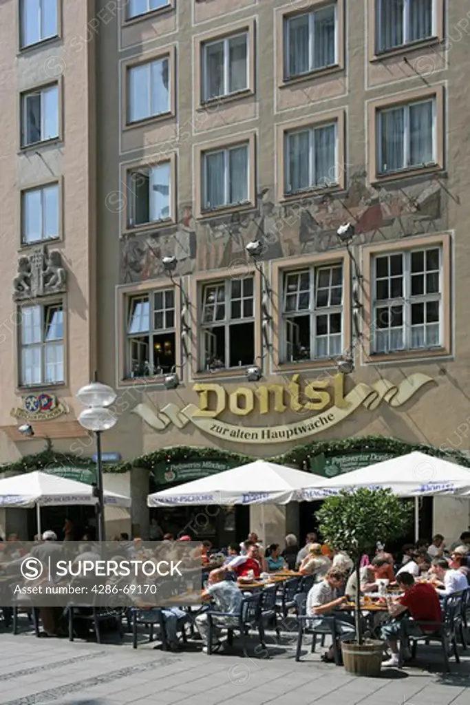 Germany Bavaria Munich People sitting outside the popular Donisl restaurant