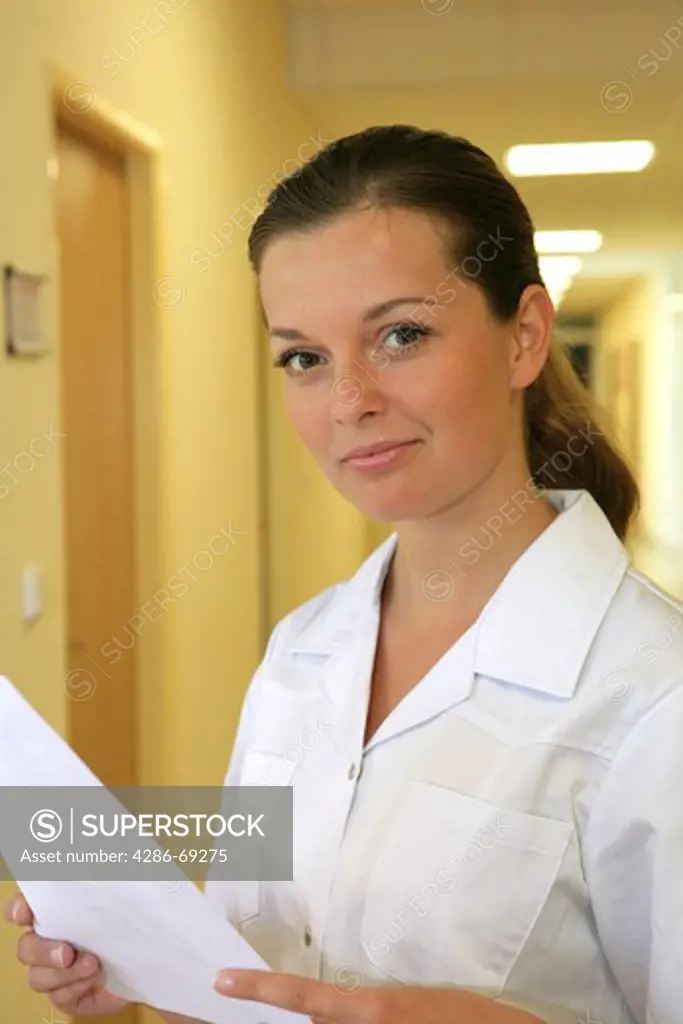 nurse standing in hospital corridor