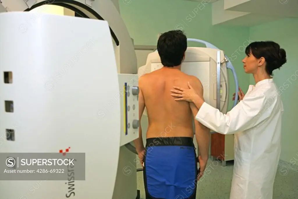 Radiographer taking x ray of patient
